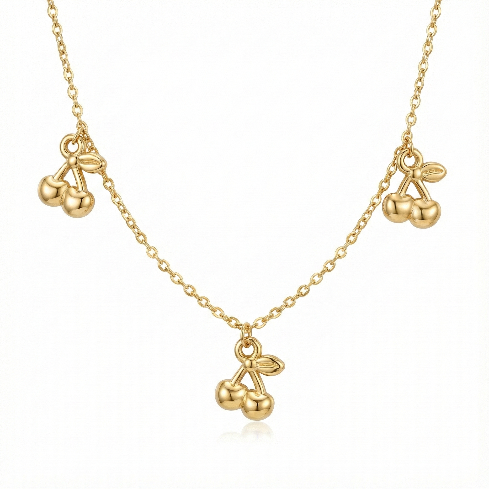 Collier tendance style coquette aesthetic : pendentif cerises dorées (cherry) en relief sur chaîne acier inoxydable.