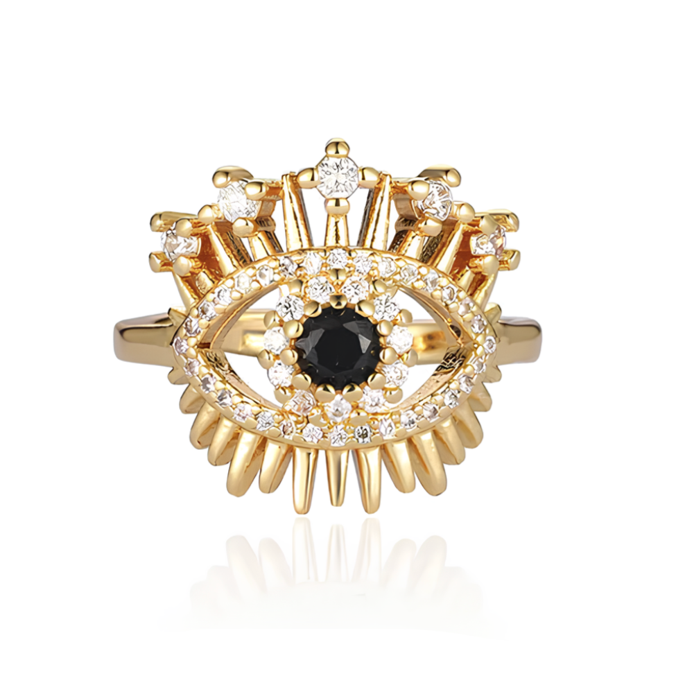 Portez la force du regard protecteur avec cette bague œil dorée en acier inoxydable, sublimée de strass blancs éclatants et d’un œil noir central mystérieux. Inspirée de l’œil de Nazar, cette bague œil protecteur femme allie symbolisme et sophistication dans un design éclatant.