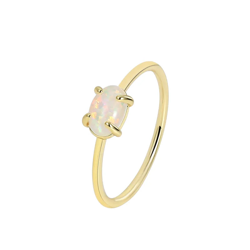 Bague dorée or 18K pour femme, ornée d’une pierre ovale effet opale aux reflets irisés, au style minimaliste et poétique, symbole de féminité et de lumière délicate.