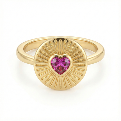 Bague médaillon solaire en acier inoxydable doré avec cœur rose fuchsia facetté et rayons ciselés, bijou symbolique lumineux