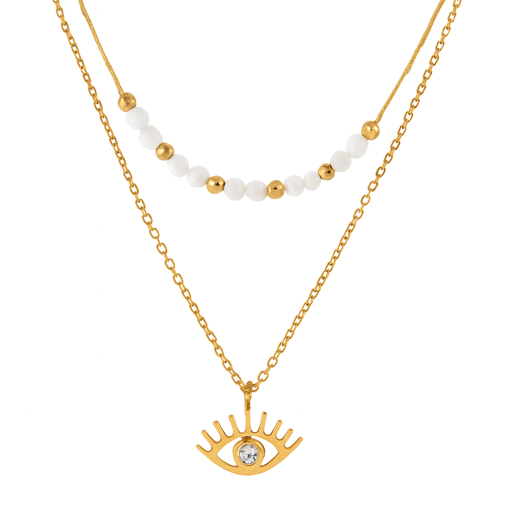 Un collier raffiné à double chaîne, combinant une rangée de perles blanches et dorées avec un pendentif œil protecteur serti d’un strass. Une pièce symbolique et élégante, parfaite pour une touche mystique chic.

Matériau : Acier inoxydable couleur doré, perles synthétiques blanches et dorées, strass central. Résistant à l’eau et hypoallergénique.

Dimensions : Longueur 1ᵉʳ rang 39 + 4 cm – 2ᵉ rang 41 + 4 cm – pendentif œil 1 cm – poids 3,27 g.

Design : Deux chaînes dorées superposées. La première ornée de