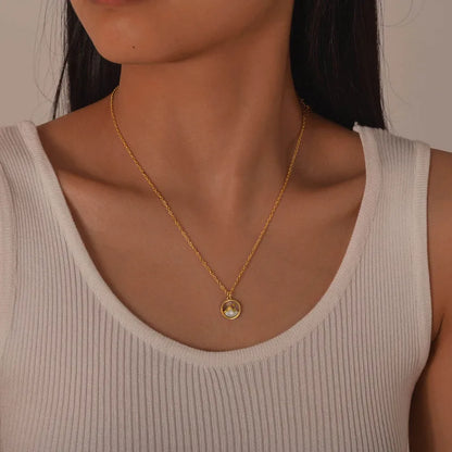 collier femme en acier inoxydable doré avec médaillon rond représentant un paysage de montagne sur fond nacré, longueur 45 à 50 cm, bijou poétique et discret inspiré de la nature