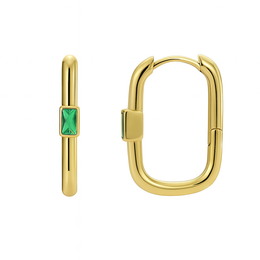 Ces créoles rectangulaires en plaqué or incarnent une modernité assumée, sublimée par une pierre verte taillée en baguette au centre. Leur silhouette ovale à coins arrondis évoque un design contemporain et structuré, idéal pour affirmer un style tendance et urbain.

L’éclat vibrant de la pierre verte crée un point de lumière coloré, subtile mais expressif, qui attire le regard sans surcharge. La finition lisse et brillante du plaqué or souligne la pureté des lignes et garantit une touche de luxe discret.